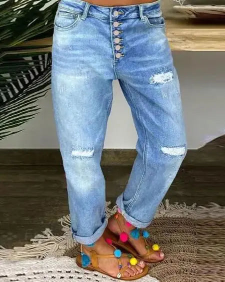Gescheurde jeans met lage taille en knoopgulp 