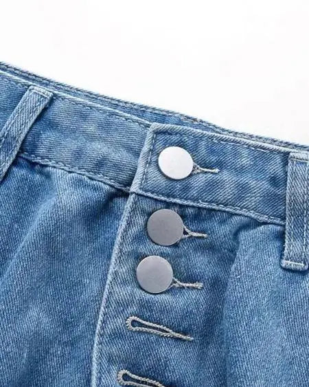 Gescheurde jeans met lage taille en knoopgulp 